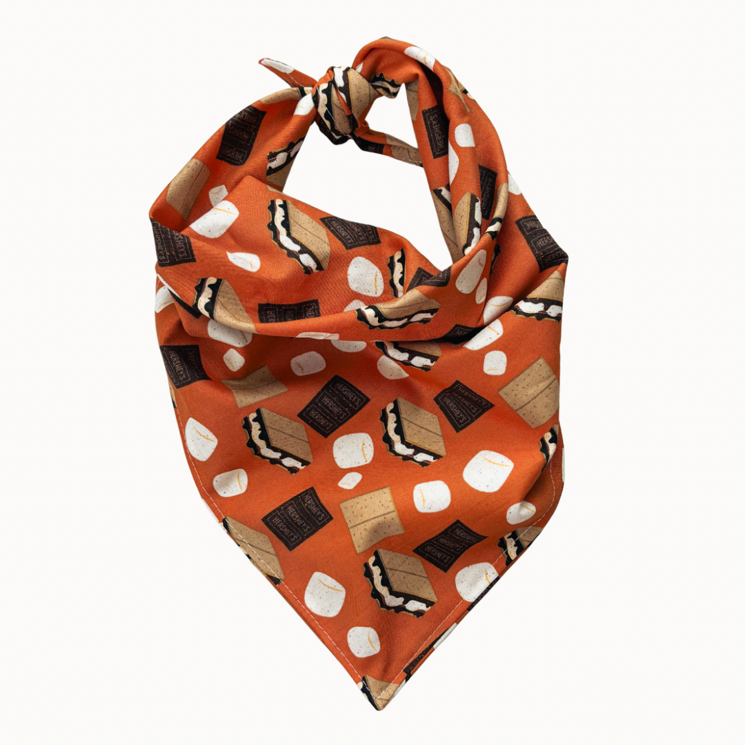 Orange bandana with marshmallow and graham cracker pattern on a white background